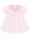 Carriage Boutique baby girl pink cotton bishop dress with hand-smocked pearl cross detail and matching bonnet.