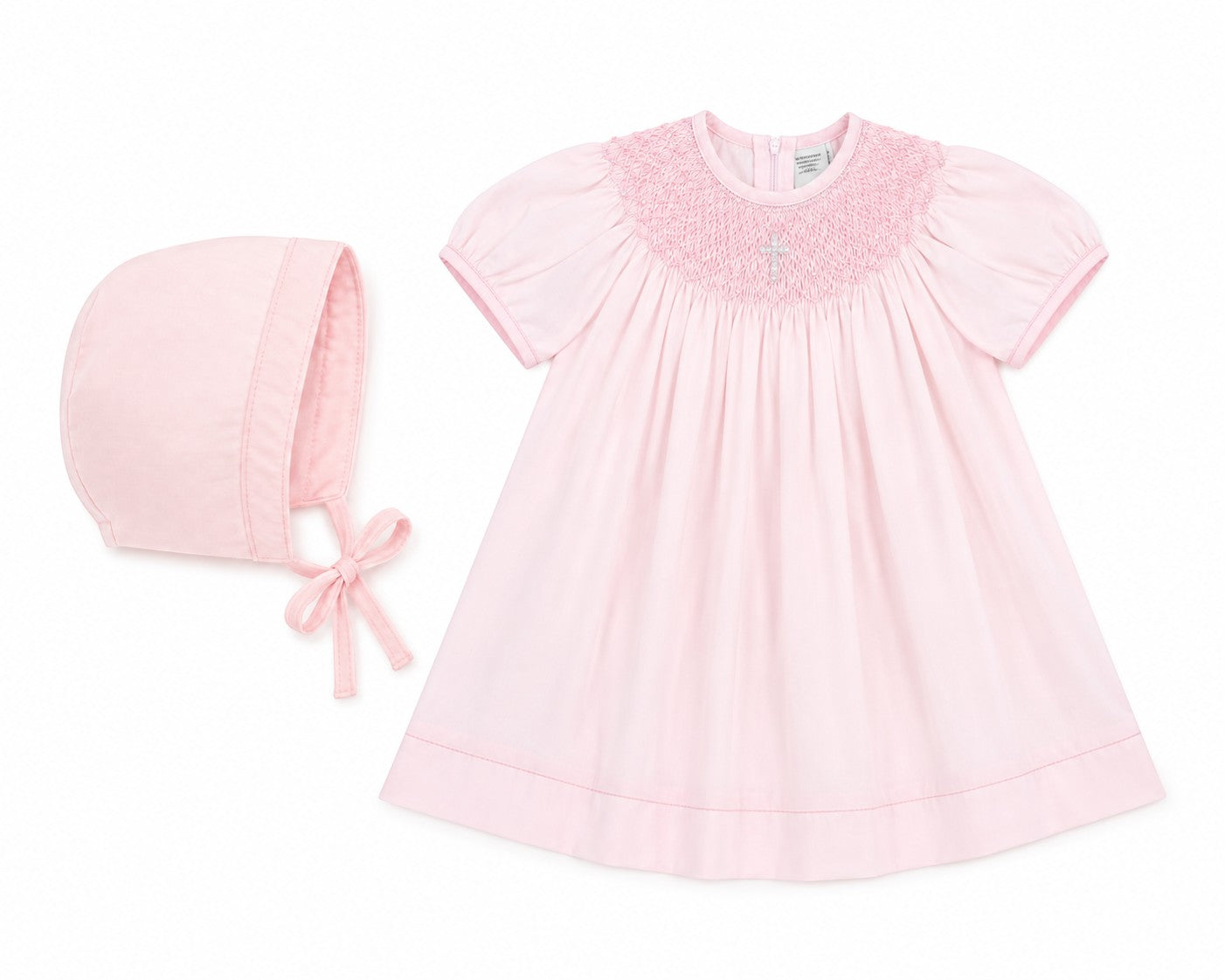 Carriage Boutique baby girl pink cotton bishop dress with hand-smocked pearl cross detail and matching bonnet.