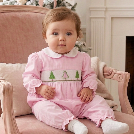 Carriage Boutique baby girl wearing a pink long-sleeve cotton longall with smocked Christmas tree embroidery