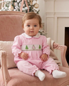 Carriage Boutique baby girl wearing a pink long-sleeve cotton longall with smocked Christmas tree embroidery