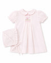 Carriage Boutique pale pink smocked heirloom dress with bird embroidery, Peter Pan collar, and matching ruffled bonnet.