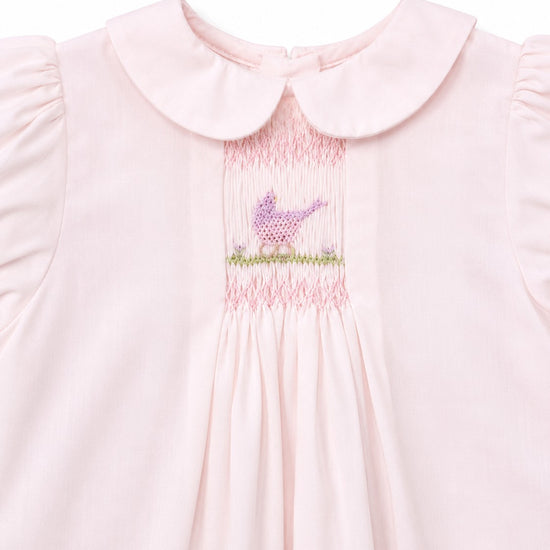 Carriage Boutique pale pink baby dress with hand-smocked bodice, bird embroidery, and Peter Pan collar.