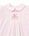 Carriage Boutique pale pink baby dress with hand-smocked bodice, bird embroidery, and Peter Pan collar.