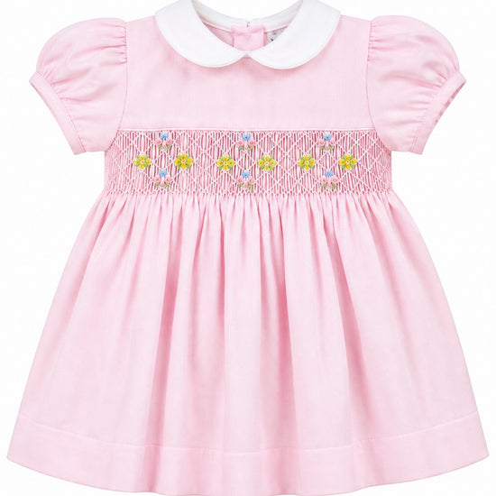 Carriage Boutique baby girl pink pique dress with white peter pan collar and hand smocked floral waist detail