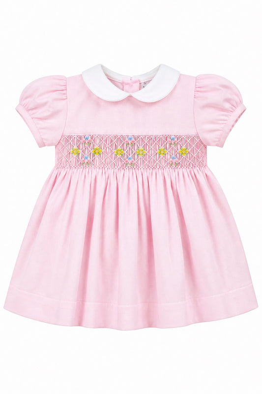 Carriage Boutique baby girl pink pique dress with white peter pan collar and hand smocked floral waist detail