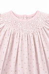 Carriage Boutique pink cotton baby dress featuring delicate rosebud print and intricate white hand-smocked neckline.