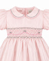 Carriage Boutique pink taffeta toddler dress featuring hand smocked detailing, a peter pan collar, and short sleeves.