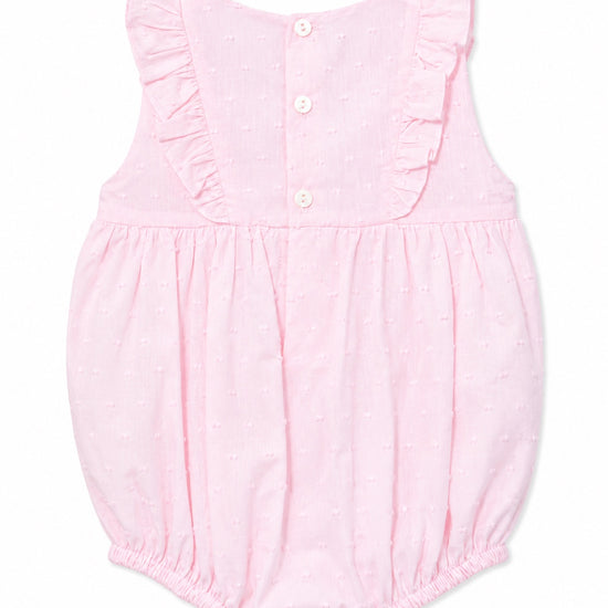 Carriage Boutique baby girl bubble romper in soft pink with Swiss dot texture, ruffled shoulders, and back buttons.