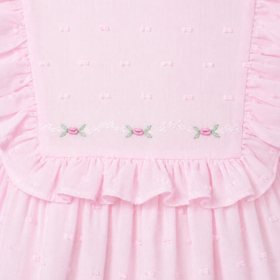 Carriage Boutique pink toddler dress with Swiss dot texture, ruffled bodice, and delicate floral embroidery detail.
