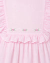 Carriage Boutique pink toddler dress with Swiss dot texture, ruffled bodice, and delicate floral embroidery detail.