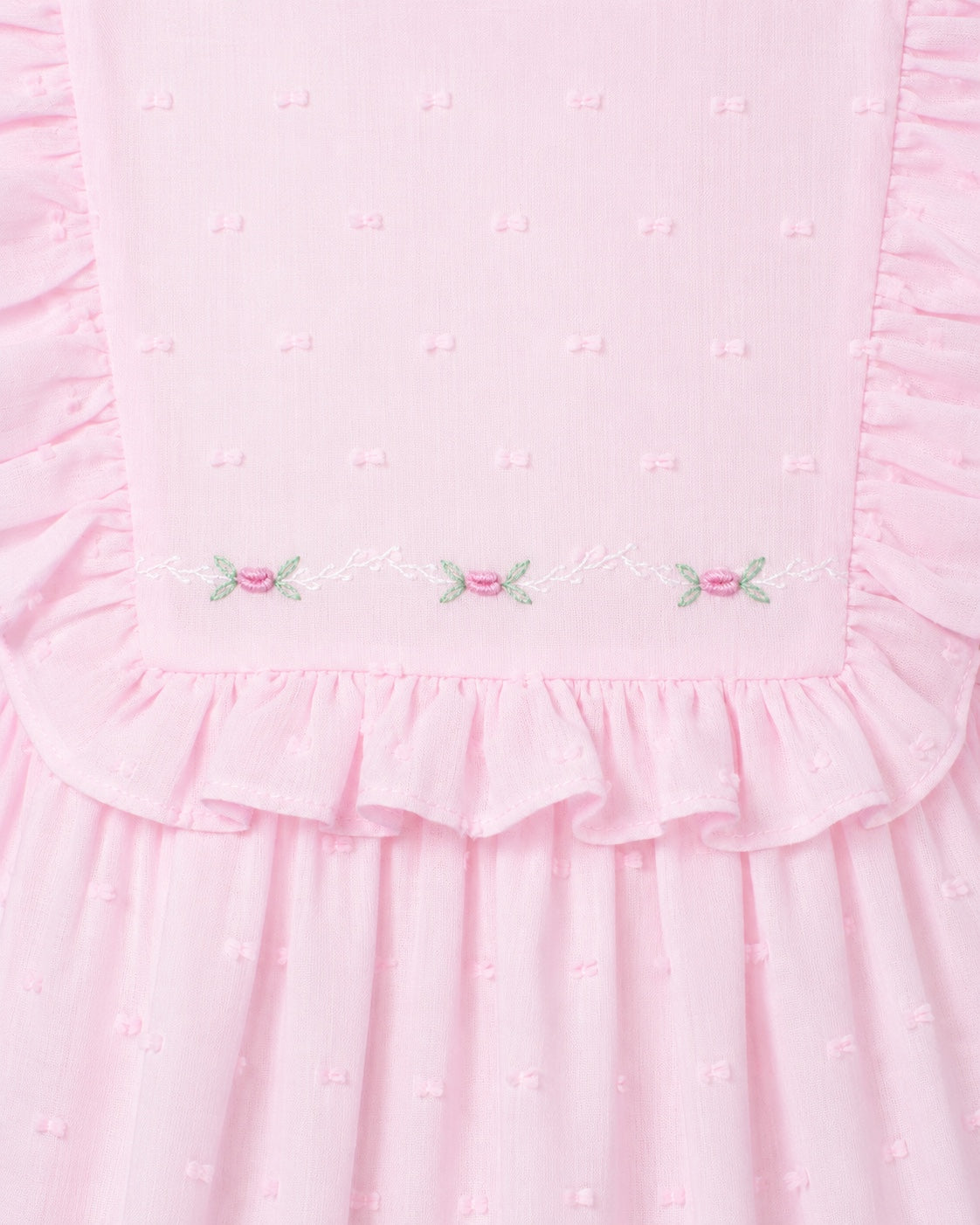 Carriage Boutique pink toddler dress with Swiss dot texture, ruffled bodice, and delicate floral embroidery detail.