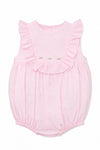 Carriage Boutique baby girl bubble romper in soft pink with Swiss dot texture, ruffled shoulders, and floral detail.