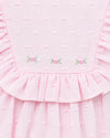 Carriage Boutique pink baby bubble romper with Swiss dot texture, ruffled yoke, and delicate floral embroidery.