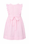 Carriage Boutique pink toddler dress with Swiss dot texture, ruffled sleeves, and a back tie waist.