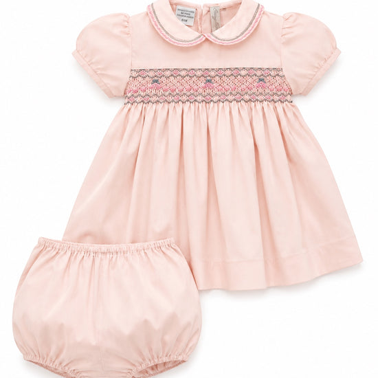 Carriage Boutique pink taffeta baby girl dress with hand-smocked floral waist, puffed sleeves, and matching bloomers.