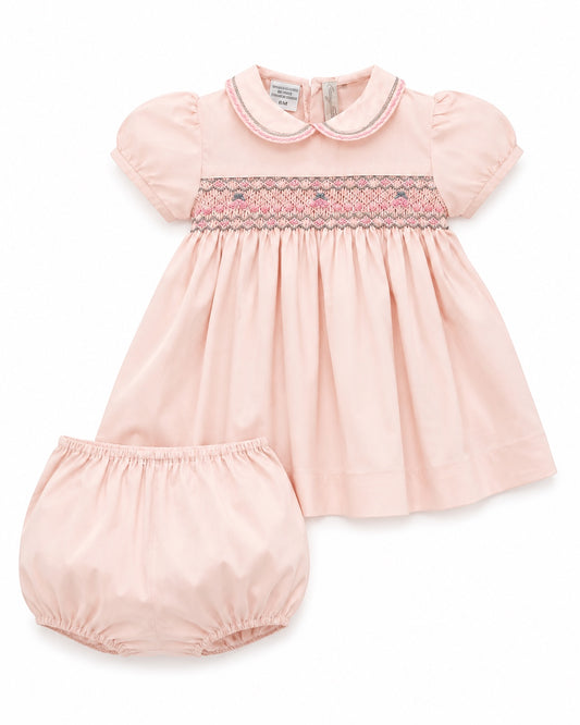Carriage Boutique pink taffeta baby girl dress with hand-smocked floral waist, puffed sleeves, and matching bloomers.