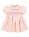 Carriage Boutique pink taffeta baby girl dress with short puffed sleeves and delicate hand-smocked floral waist detail.