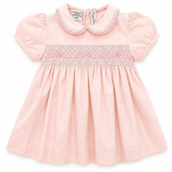 Carriage Boutique pink taffeta baby girl dress with hand-smocked floral waist, peter pan collar, and puffed sleeves.