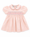 Carriage Boutique pink taffeta baby girl dress with hand-smocked floral waist, peter pan collar, and puffed sleeves.