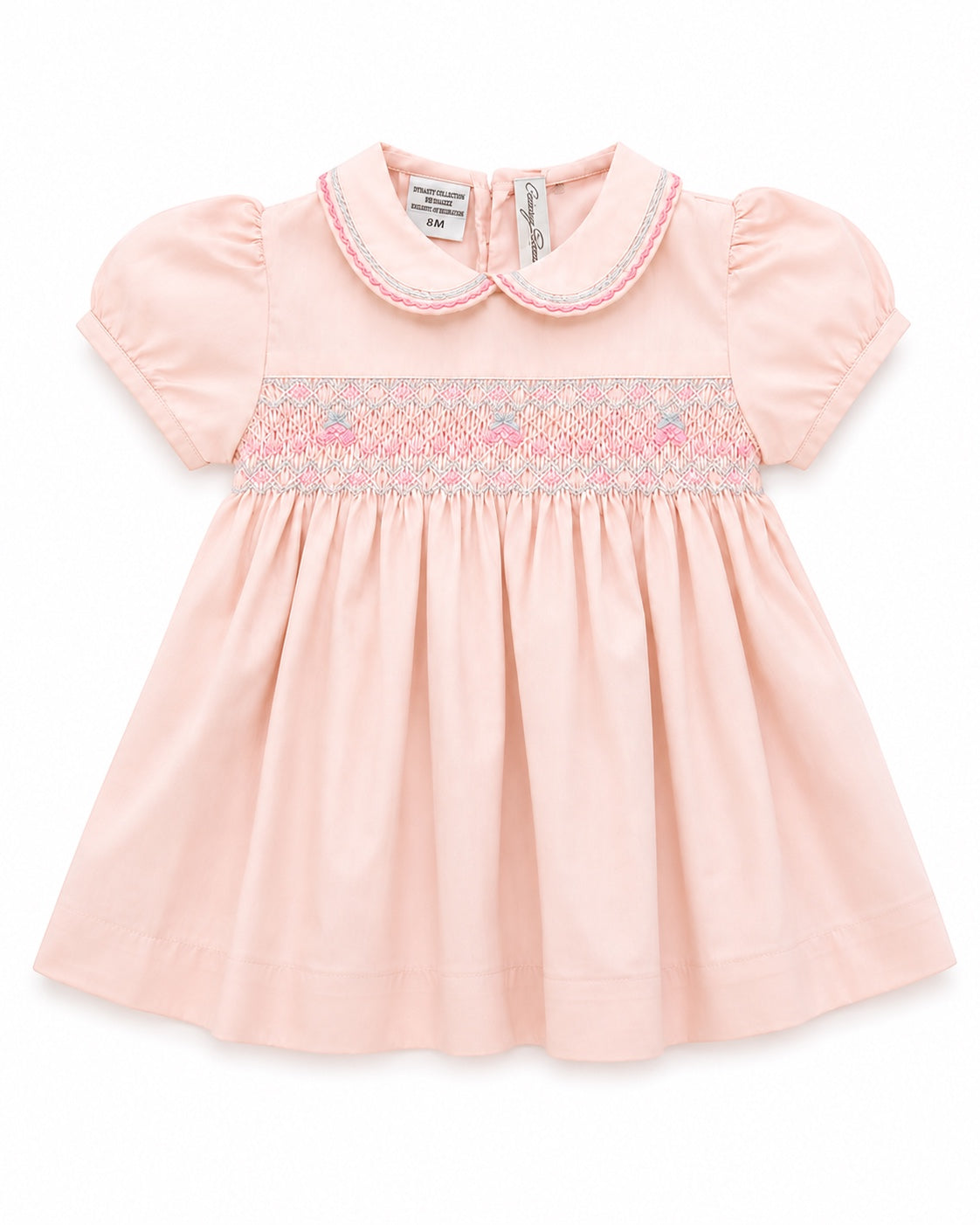 Carriage Boutique pink taffeta baby girl dress with hand-smocked floral waist, peter pan collar, and puffed sleeves.