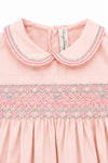 Carriage Boutique pink taffeta baby girl dress with a Peter Pan collar and intricate hand-smocked floral detailing.