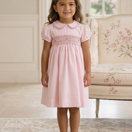 Carriage Boutique pink taffeta toddler girl dress with hand smocked bodice, peter pan collar, and short sleeves.