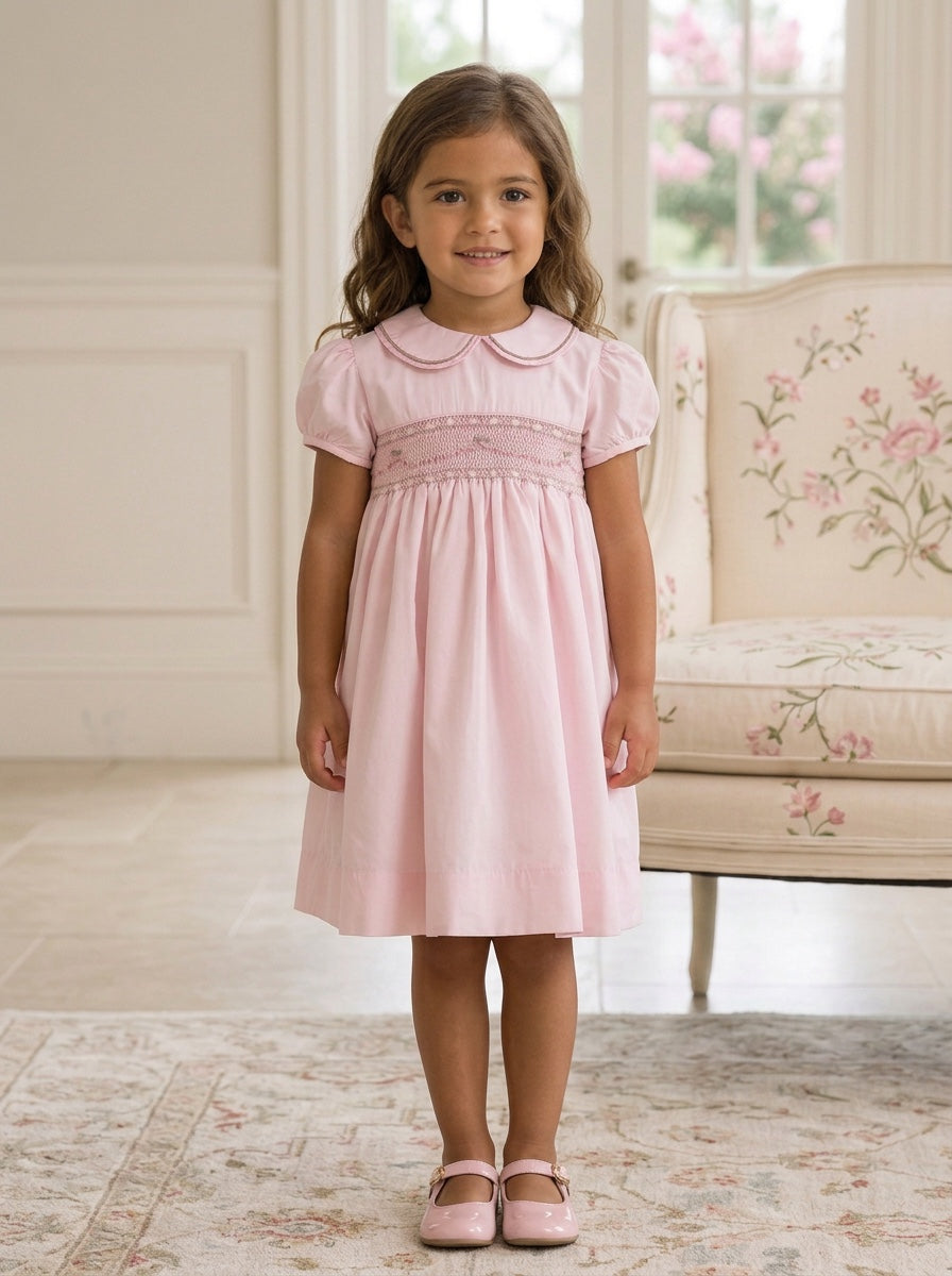 Carriage Boutique pink taffeta toddler girl dress with hand smocked bodice, peter pan collar, and short sleeves.