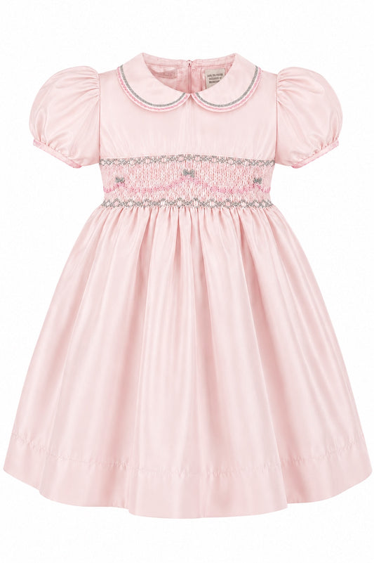 Carriage Boutique pink taffeta toddler girl dress with hand smocked bodice, peter pan collar, and puff sleeves.