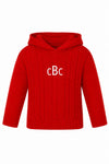 Carriage Boutique red cable knit baby sweater with a hood and white monogram embroidery on the chest
