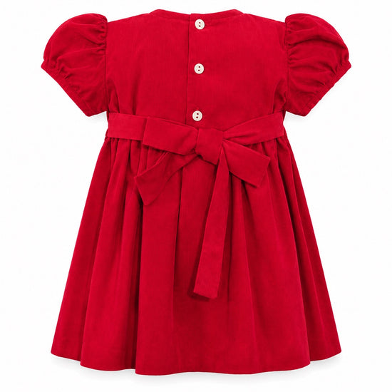 Carriage Boutique red corduroy baby girl dress with back button closure, puff sleeves, and a large waist bow tie.