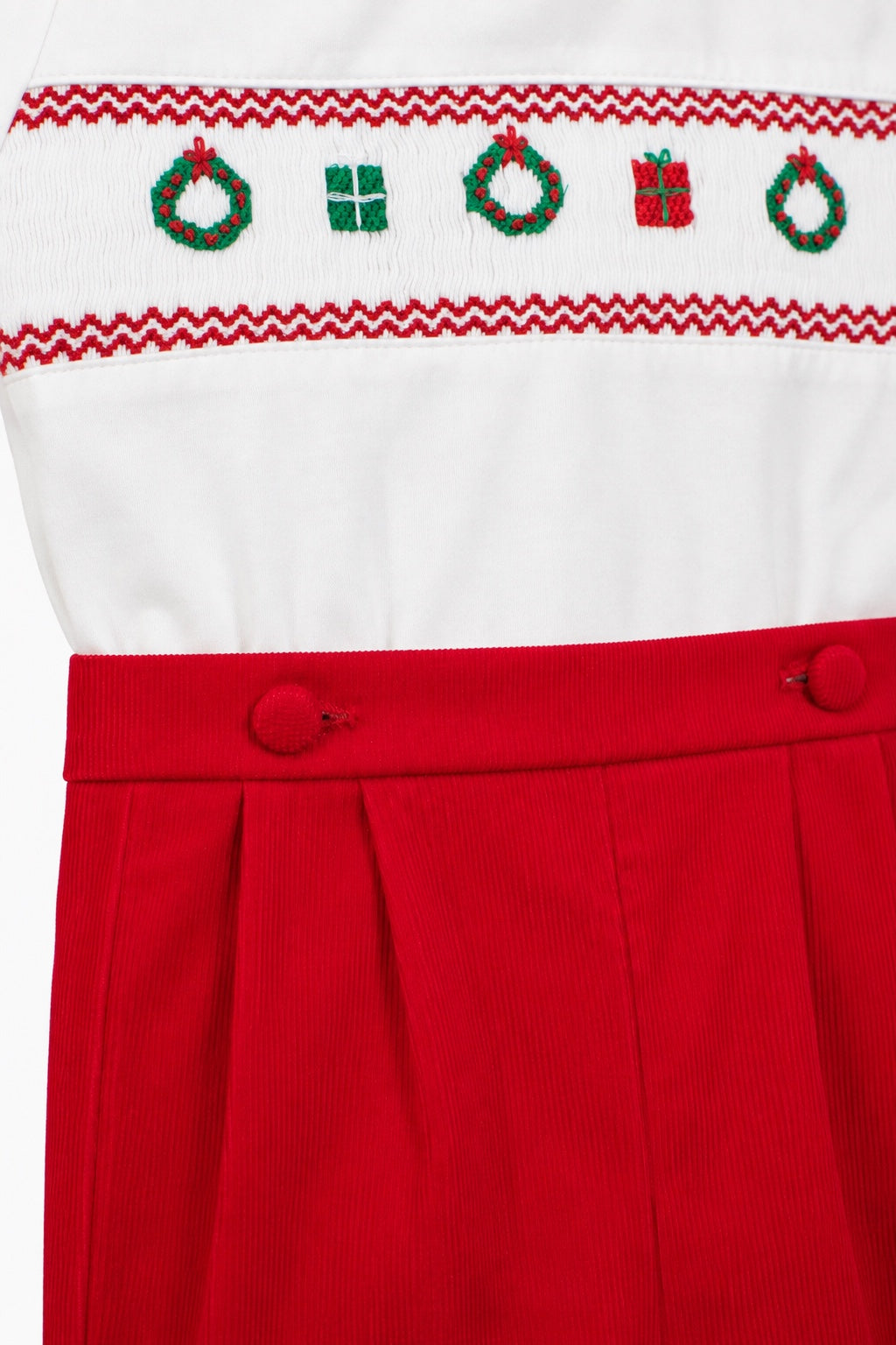 Carriage Boutique red corduroy bobby suit with white top featuring hand-smocked Christmas wreaths and gift motifs