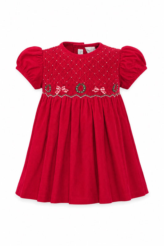 Carriage Boutique red corduroy baby girl dress with smocked bodice, Christmas wreath embroidery, and short sleeves.