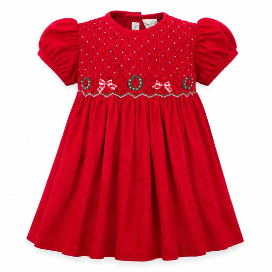 Carriage Boutique red corduroy toddler dress with smocked diamond pattern, Christmas wreaths, and bows.