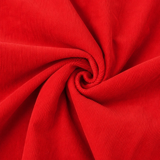 Close-up of Carriage Boutique red corduroy fabric with a soft, textured swirl pattern for baby clothing.