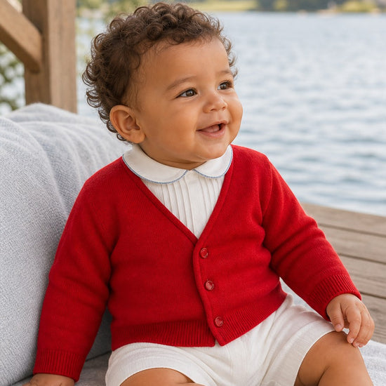 Carriage Boutique red cotton cardigan sweater worn by a smiling toddler boy with a white collared shirt