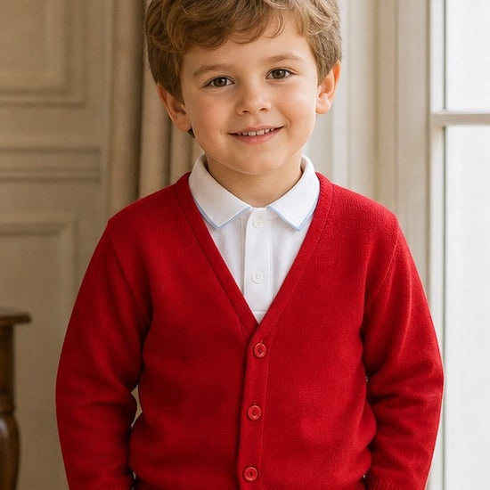 Carriage Boutique red cotton cashmere cardigan sweater worn by a smiling toddler boy with a white collared shirt.