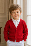 Carriage Boutique red cotton cashmere cardigan sweater worn by a smiling toddler boy with a white collared shirt.