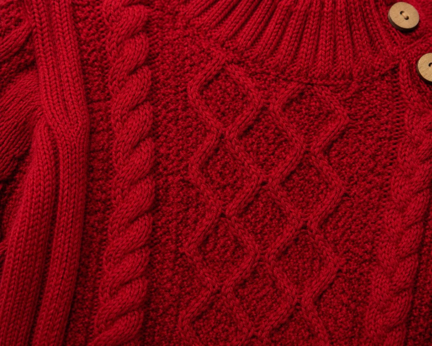 Carriage Boutique red fisherman knit pullover sweater with textured cable patterns and wooden button details.