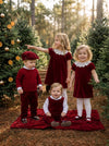 Carriage Boutique red fisherman knit pullover sweater worn by a toddler boy with a matching cap in a forest setting.