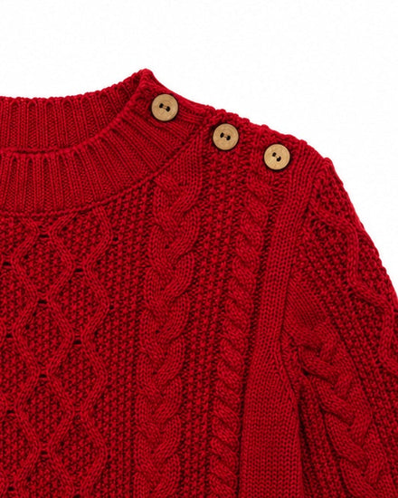 Carriage Boutique red fisherman knit pullover sweater with wooden shoulder buttons and textured cable knit pattern.