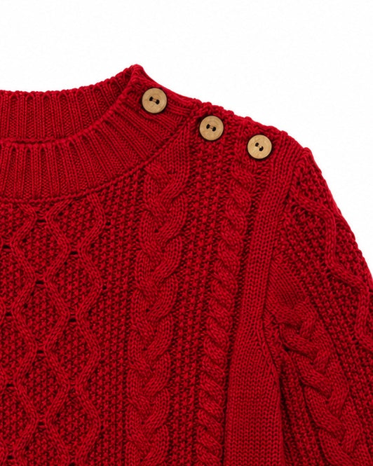 Carriage Boutique red fisherman knit pullover sweater with wooden shoulder buttons and textured cable knit pattern.