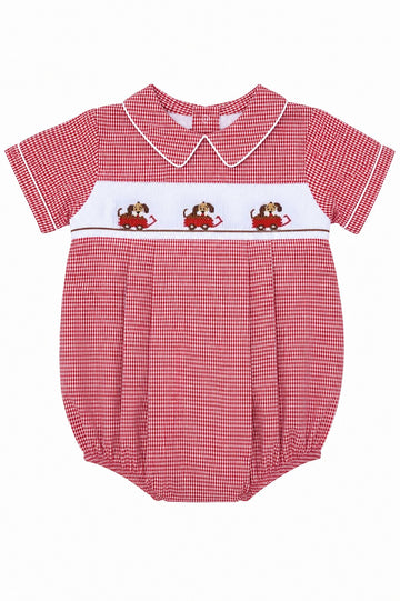 Carriage Boutique red gingham baby bubble romper with smocked bodice featuring dogs in cars, Peter Pan collar, and white piping.