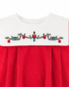 Carriage Boutique red cotton baby boy bubble romper featuring a white smocked bib with embroidered nutcracker motif.