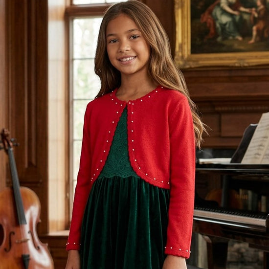 Carriage Boutique red bolero sweater with pearl accents worn by a young girl over a green velvet dress