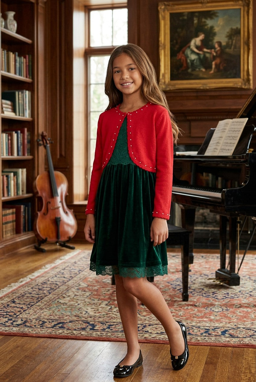 Carriage Boutique red bolero sweater with pearl accents worn by a girl over a green velvet dress in a library.