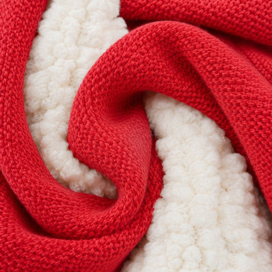 Close-up of Carriage Boutique red knit cotton fabric with soft off-white sherpa lining texture
