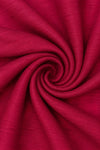 Carriage Boutique red poly silk fabric with a subtle textured weave in a swirling spiral pattern