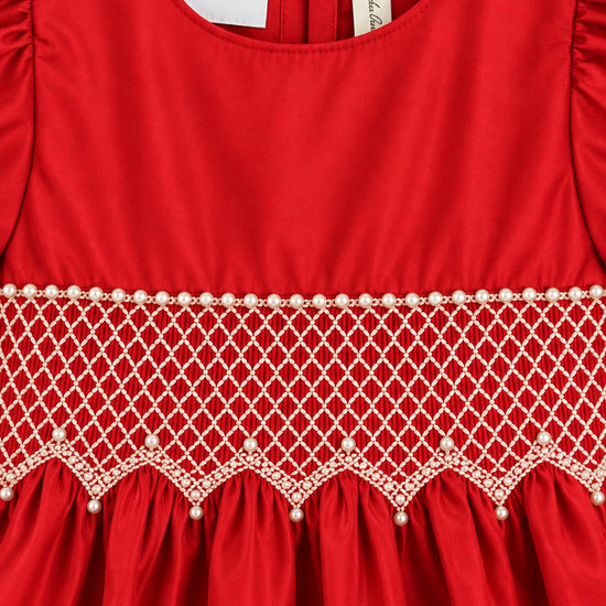 Carriage Boutique red cotton dress featuring intricate white smocked diamond detailing and delicate pearl bead accents.