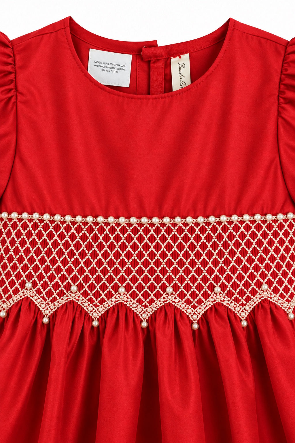 Carriage Boutique red cotton dress featuring intricate white smocked diamond detailing and delicate pearl bead accents.