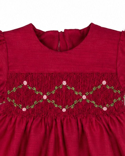 Carriage Boutique red toddler dress featuring a round neck, puffy sleeves, and intricate floral smocked detailing.